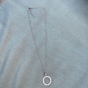Round clear gemstones circle pendant on a silver chain necklace